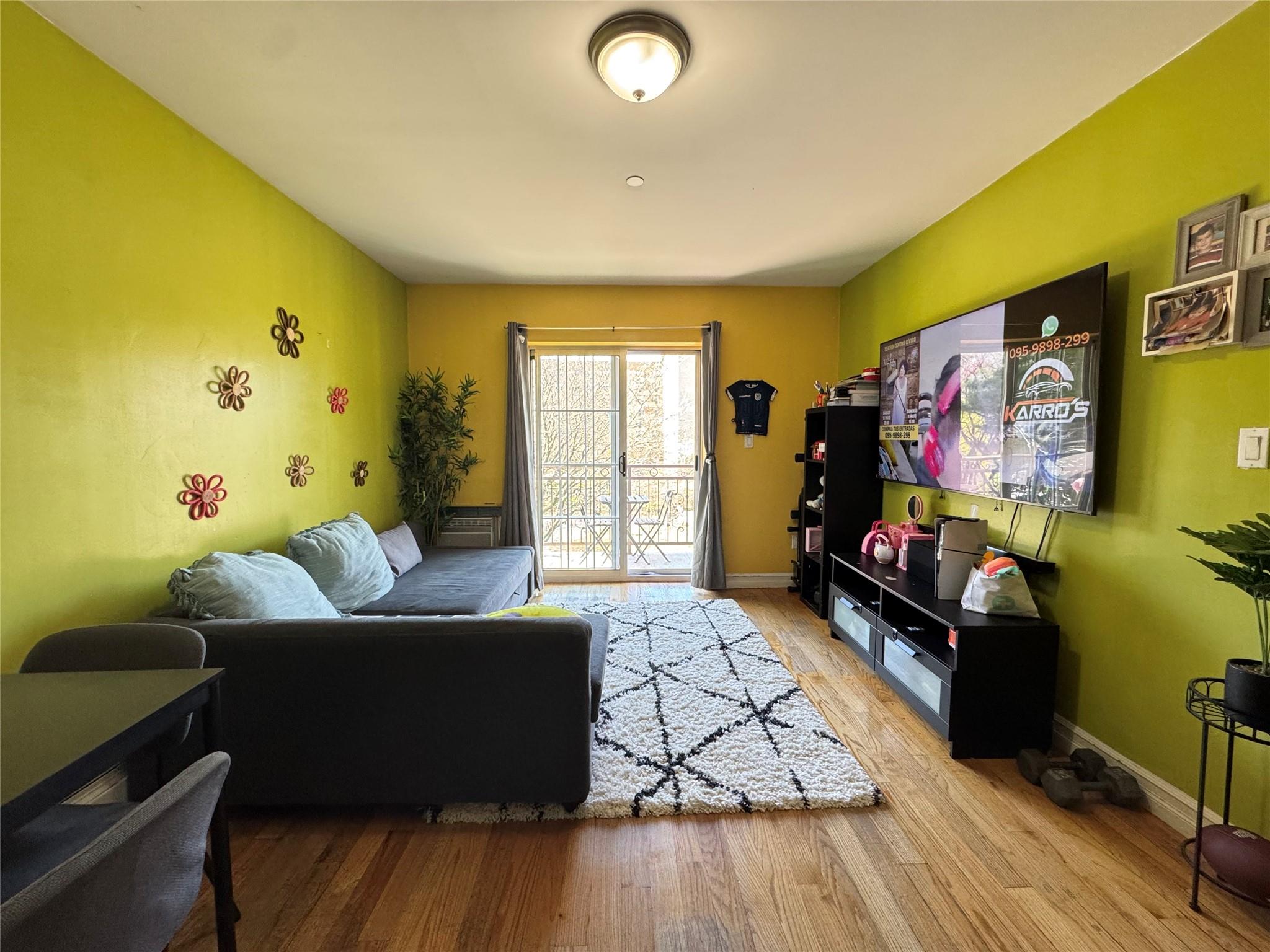 53-12 102nd Street Queens, NY 11368 - Photo 4 of 8 a living room with furniture and a flat screen tv