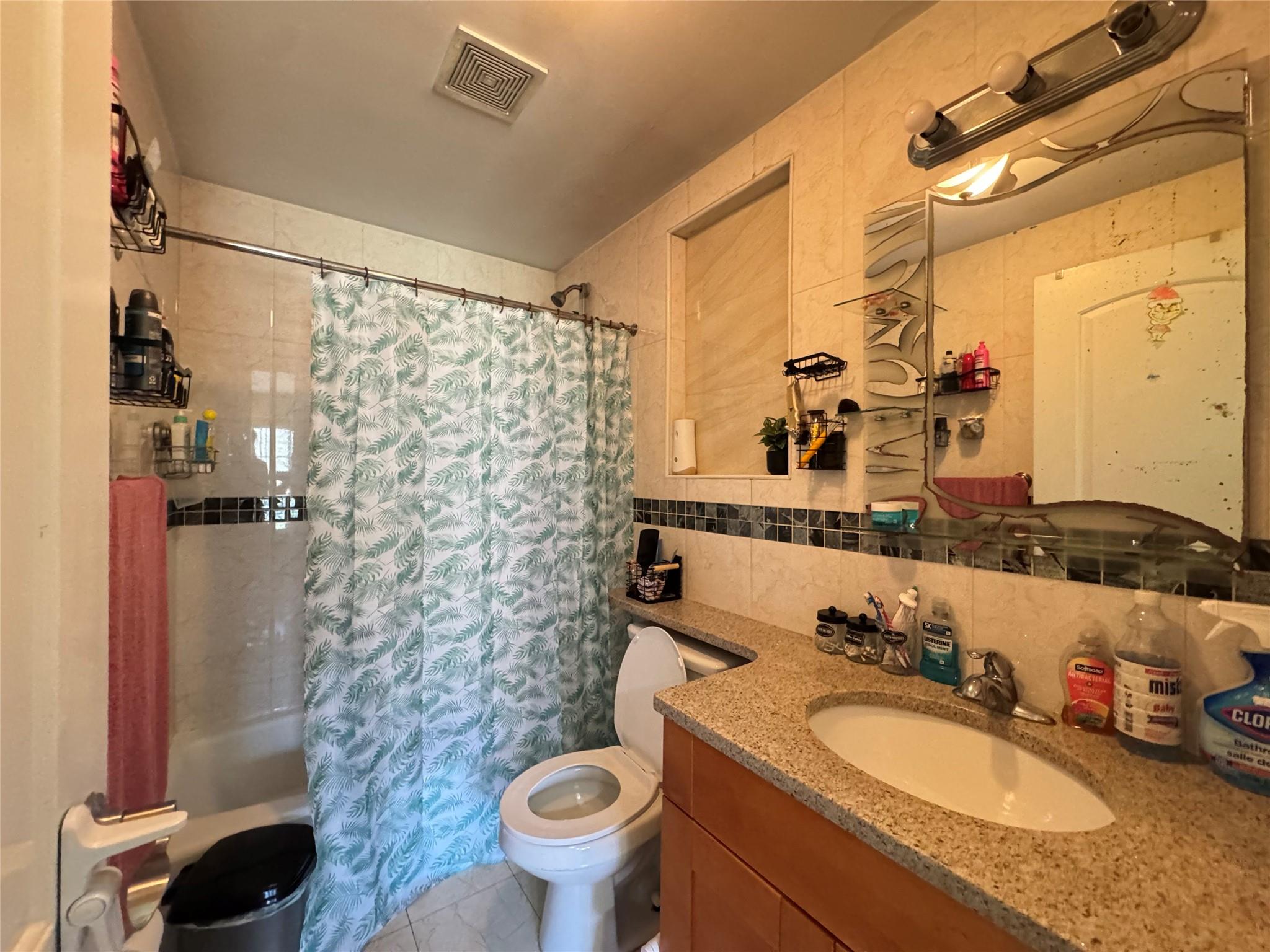 53-12 102nd Street Queens, NY 11368 - Photo 6 of 8 a bathroom with a granite countertop sink mirror vanity and toilet