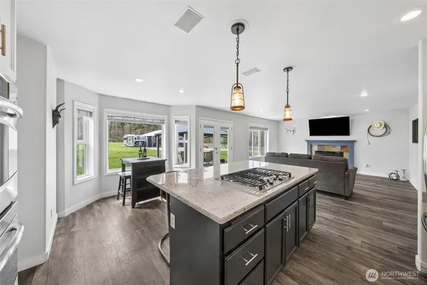 a open kitchen with stainless steel appliances granite countertop a stove and refrigerator