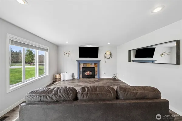 a living room with a couch a flat screen tv and a fireplace