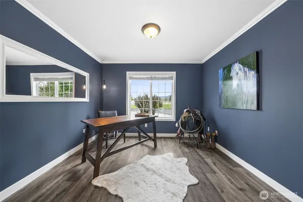 a view of a workspace with furniture and a window