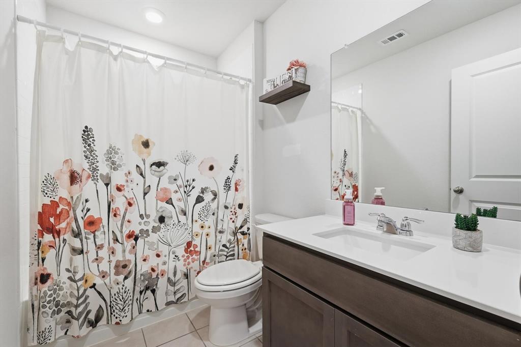 2416 Wildhaven Road Crandall, TX 75114 - Photo 22 of 35 a bathroom with a sink a toilet and shower curtain
