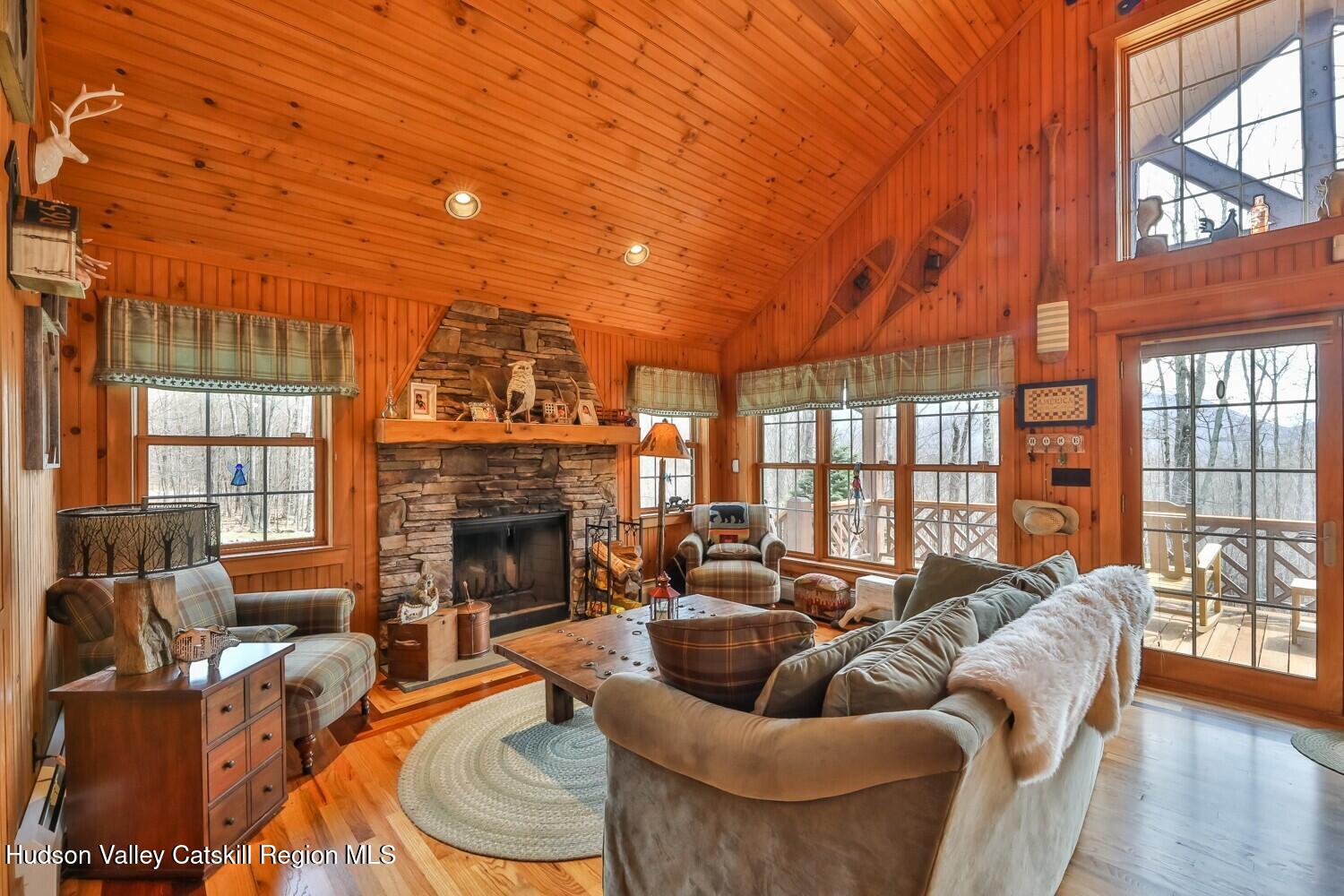 15 Hardwood Road West Kill, NY 12492 - Photo 32 of 53 a living room with furniture a fireplace and a floor to ceiling window