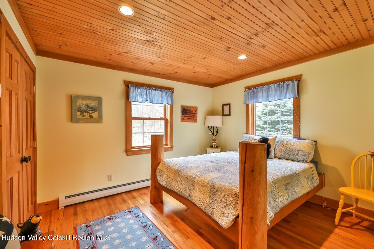 15 Hardwood Road West Kill, NY 12492 - Photo 44 of 53 a bedroom with a bed and wooden floor