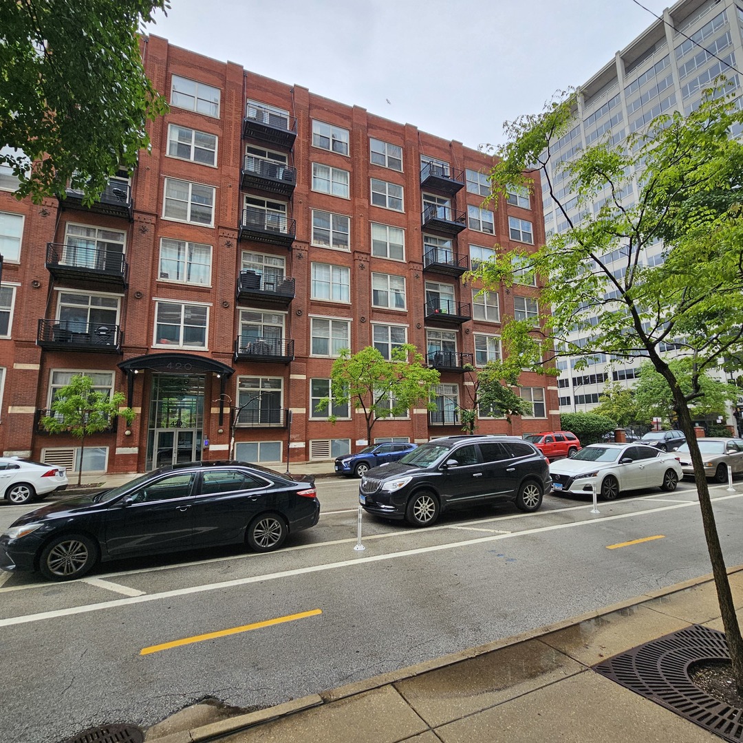 a view of a cars park in front of a building