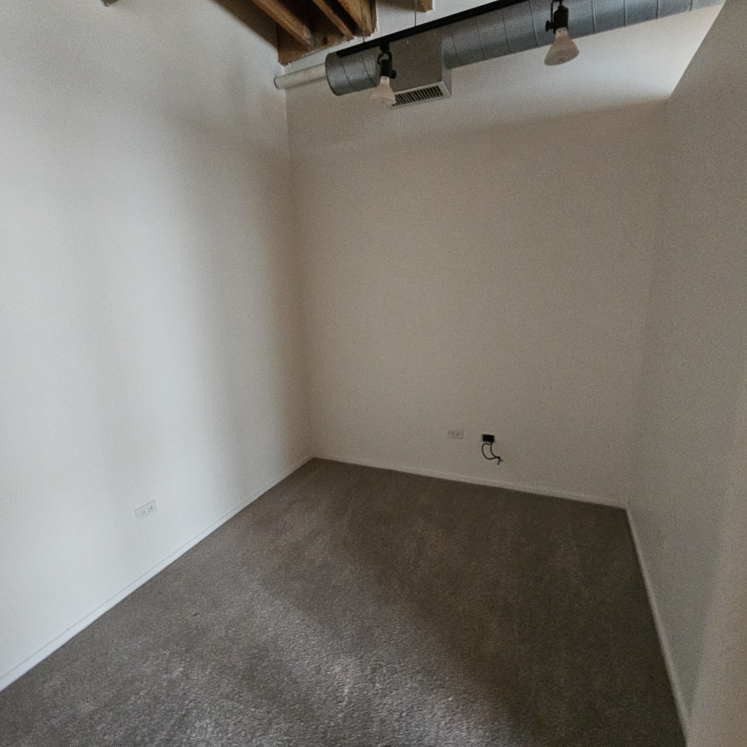 420 South Clinton Street, Unit 607 Chicago, IL 60607 - Photo 4 of 11 a view of a room with rack on the wall