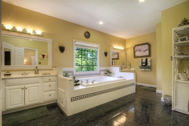 868 Reed Road Ten Mile, TN 37880 - Photo 16 of 40 a spacious bathroom with a double vanity sink a mirror and a bathtub