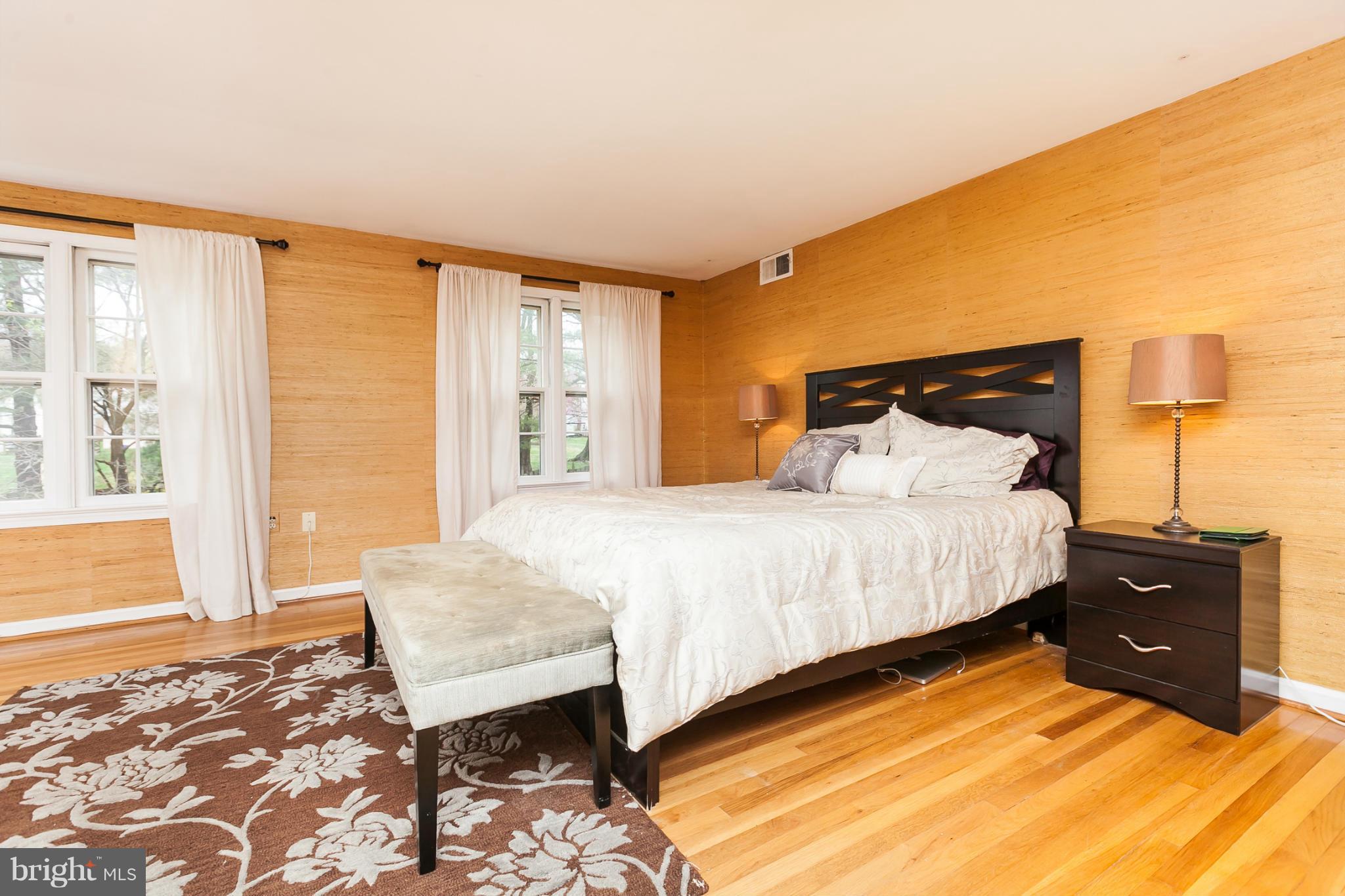 13708 Lockdale Road Silver Spring, MD 20906 - Photo 20 of 30 a bedroom with a bed and wooden floor
