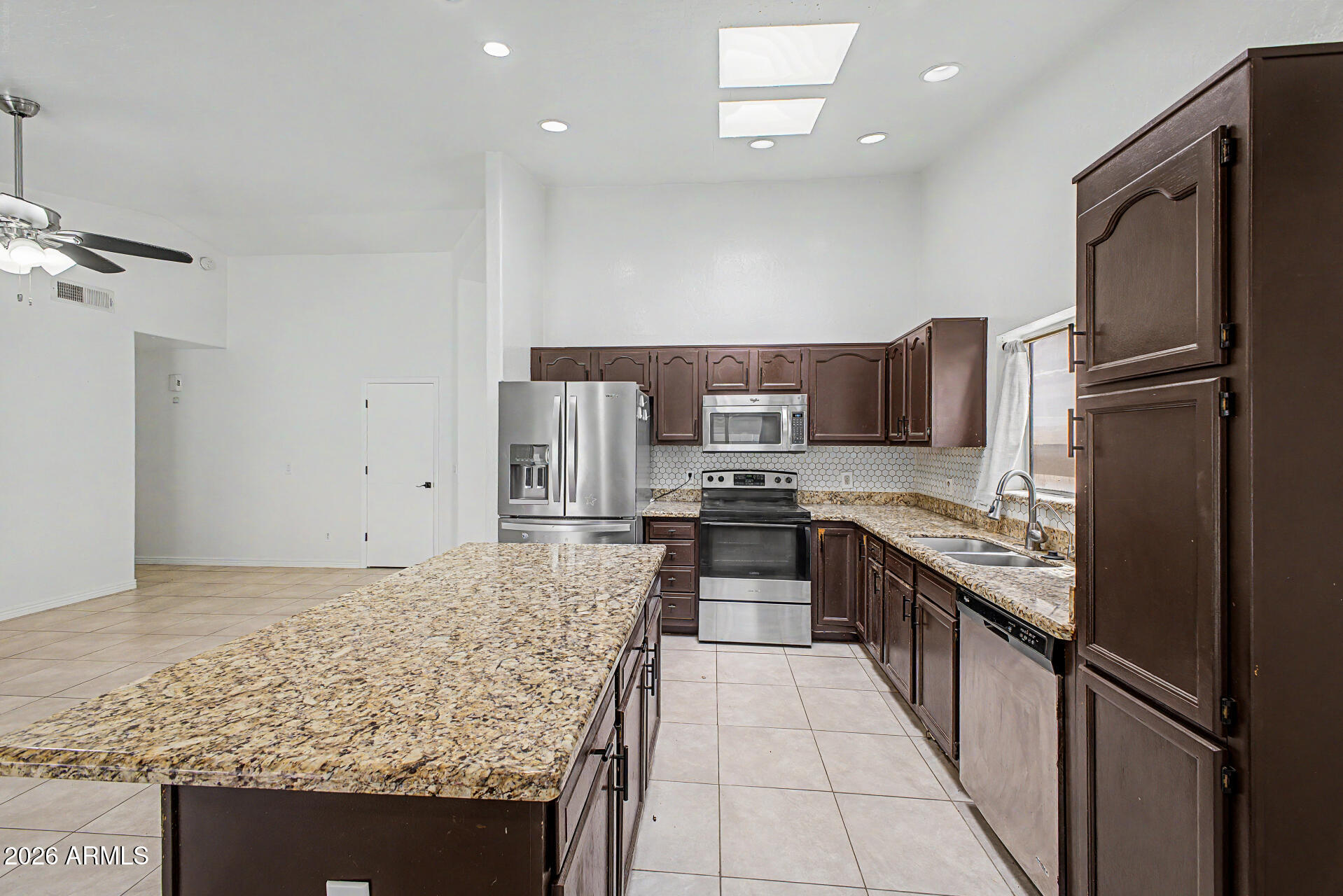 156 North Nielson Street Gilbert, AZ 85234 - Photo 11 of 32 a kitchen with stainless steel appliances granite countertop a refrigerator oven stove a sink and dishwasher