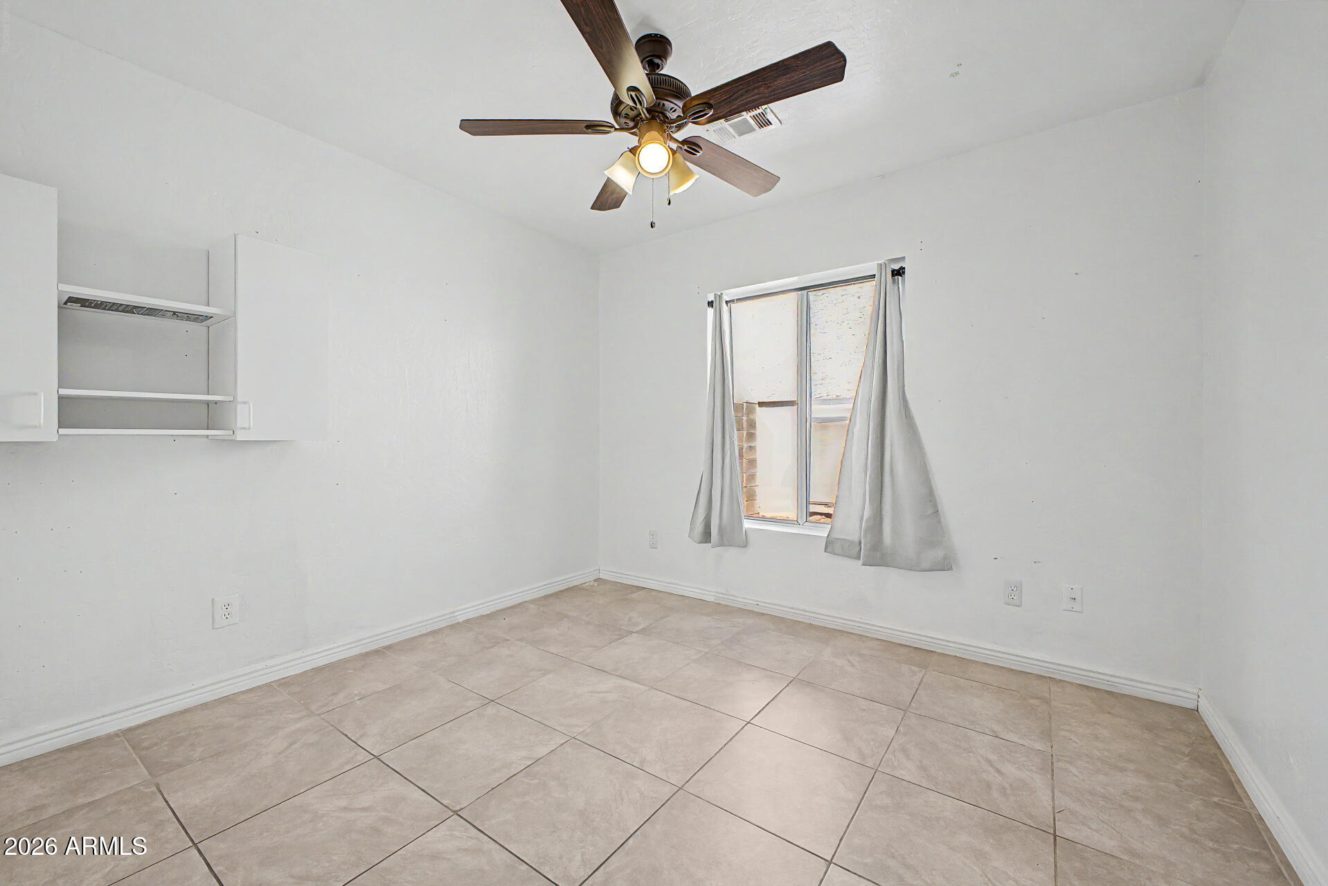 156 North Nielson Street Gilbert, AZ 85234 - Photo 19 of 32 an empty room with a window and a fan