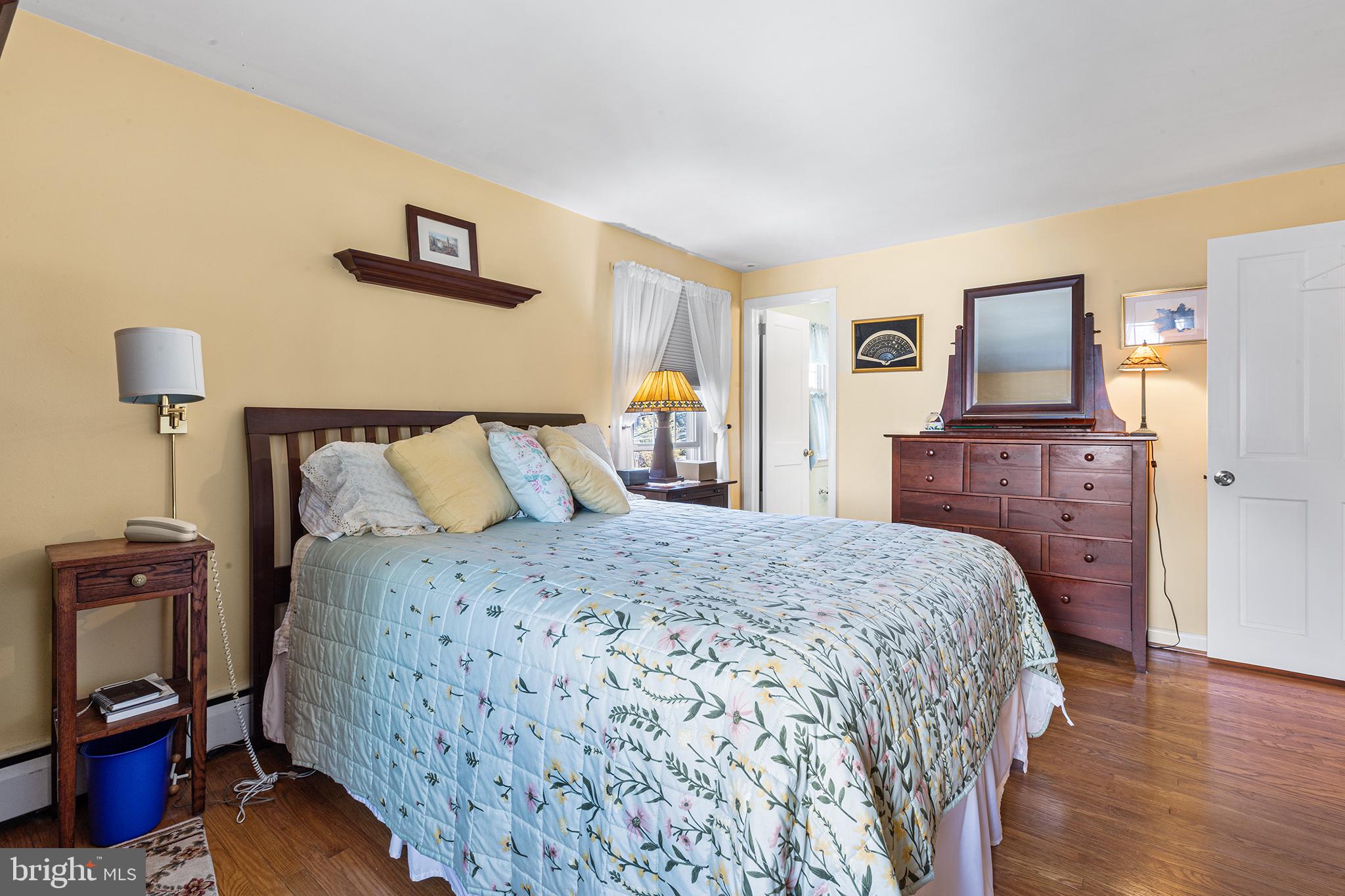 331 North Lehigh Circle Swarthmore, PA 19081 - Photo 20 of 32 a bedroom with a bed and wooden floor