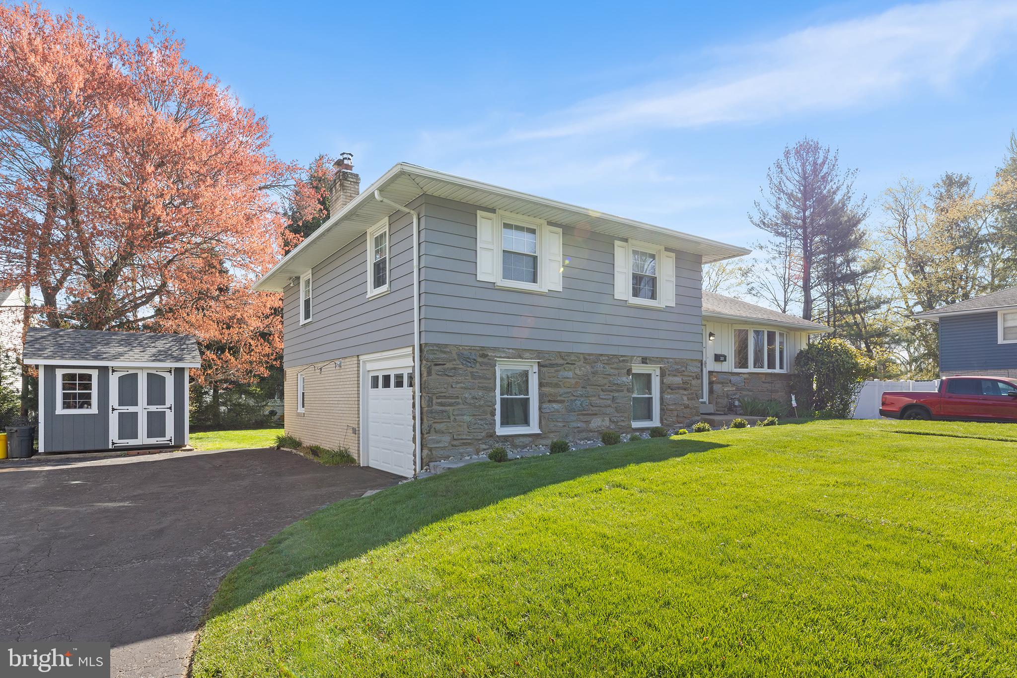 331 North Lehigh Circle Swarthmore, PA 19081 - Photo 2 of 32 a front view of a house with a garden and trees