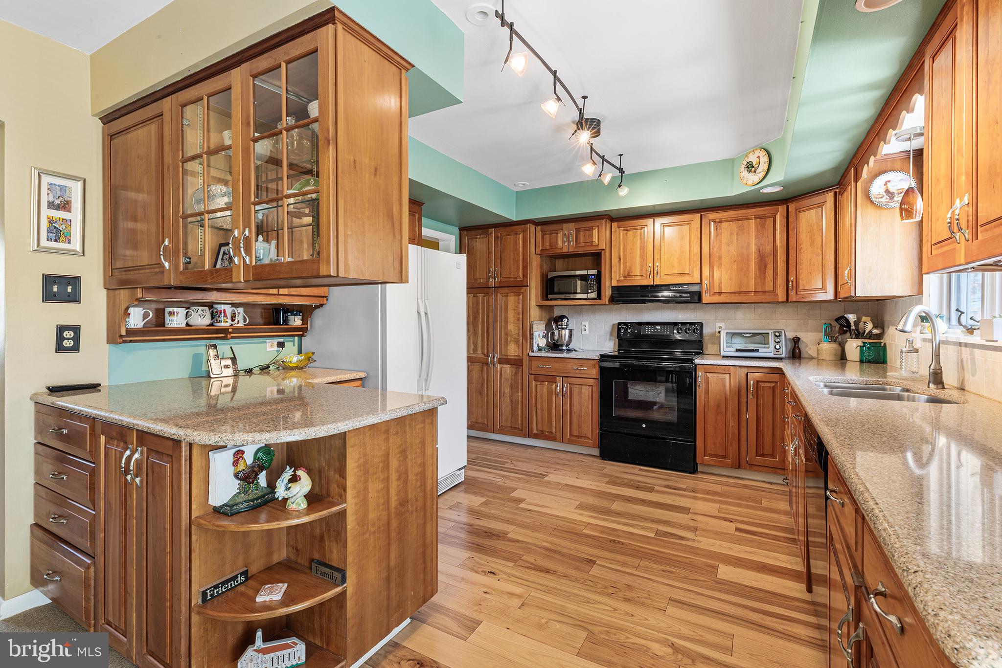 331 North Lehigh Circle Swarthmore, PA 19081 - Photo 9 of 32 a kitchen with stainless steel appliances granite countertop a stove a sink and a refrigerator