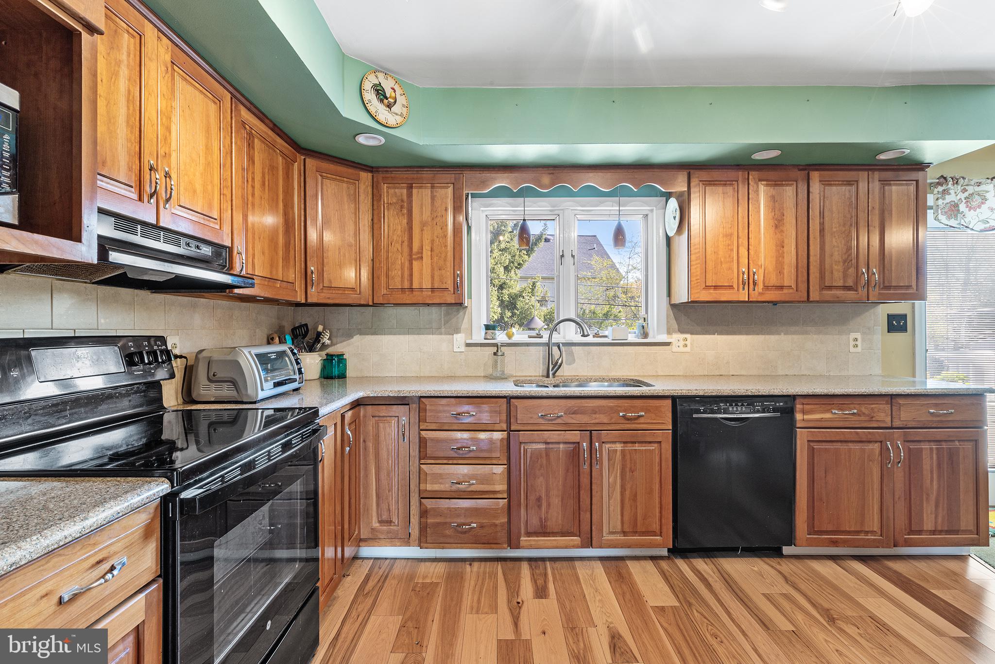 331 North Lehigh Circle Swarthmore, PA 19081 - Photo 10 of 32 a kitchen with stainless steel appliances granite countertop a stove a sink and a microwave