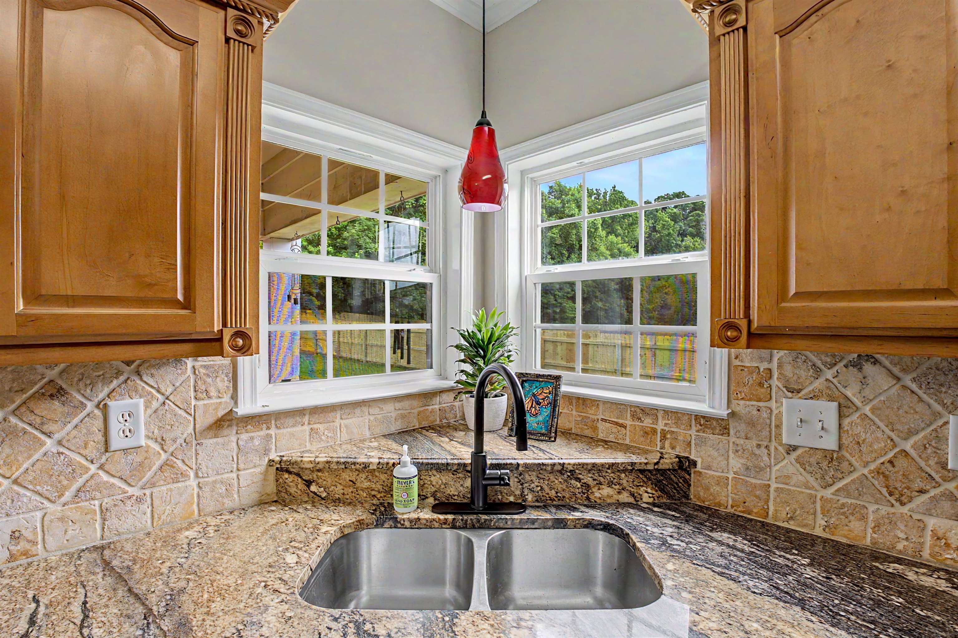 134 Rembert Drive Atoka, TN 38004 - Photo 20 of 38 Corner kitchen sink with dual basins, granite countertops, and a tiled backsplash