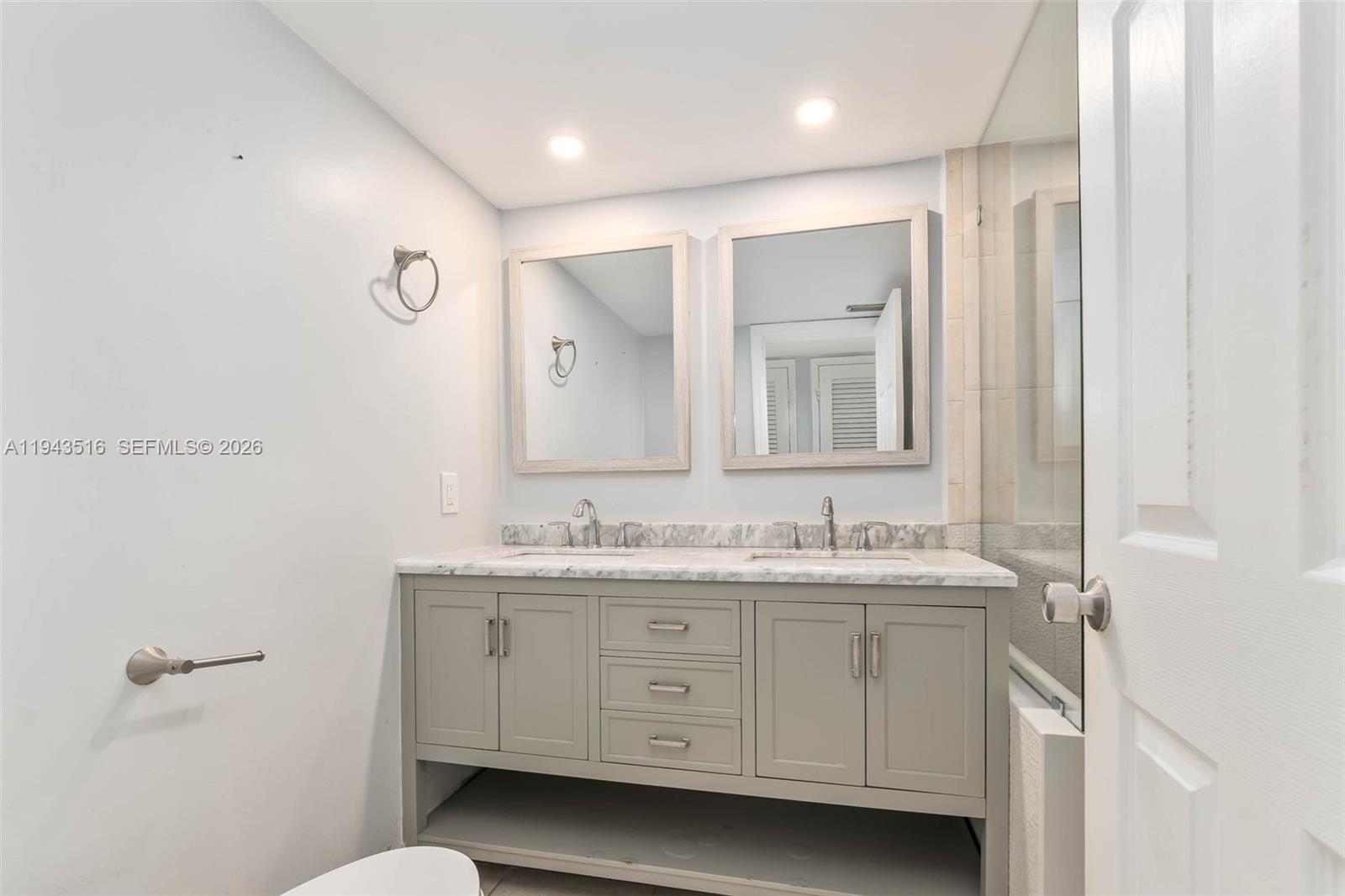 7324 Southwest 82nd Street, Unit B108 Miami, FL 33143 - Photo 11 of 17 a bathroom with a double vanity sink and mirror