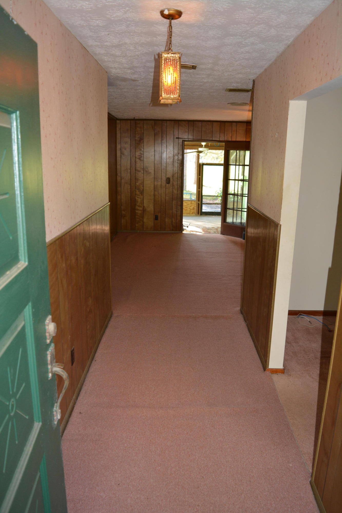 4061 Appaloosa Road Middleburg, FL 32068 - Photo 4 of 43 a view of an empty room with wooden floor and windows