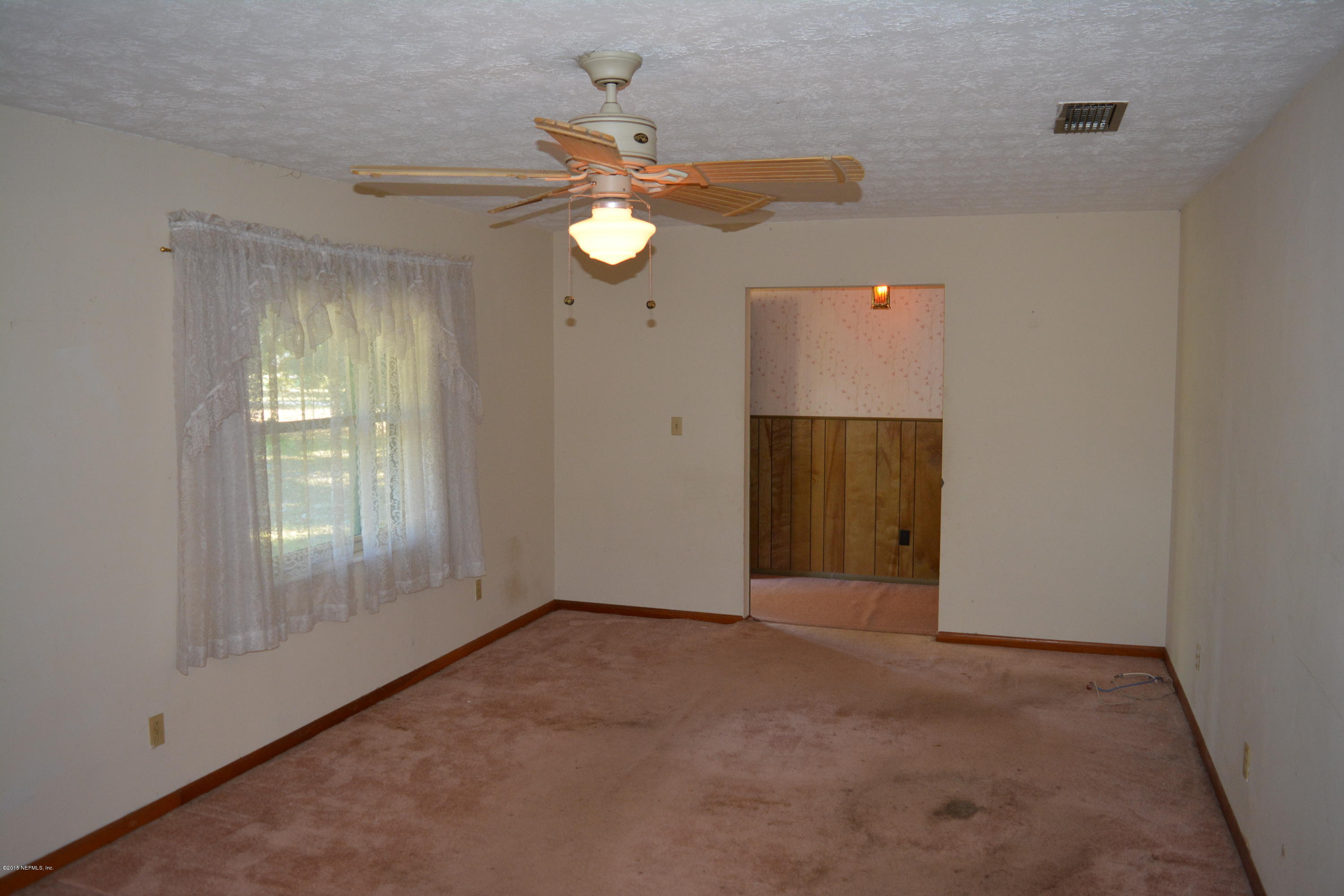 4061 Appaloosa Road Middleburg, FL 32068 - Photo 6 of 43 a view of an empty room with a window