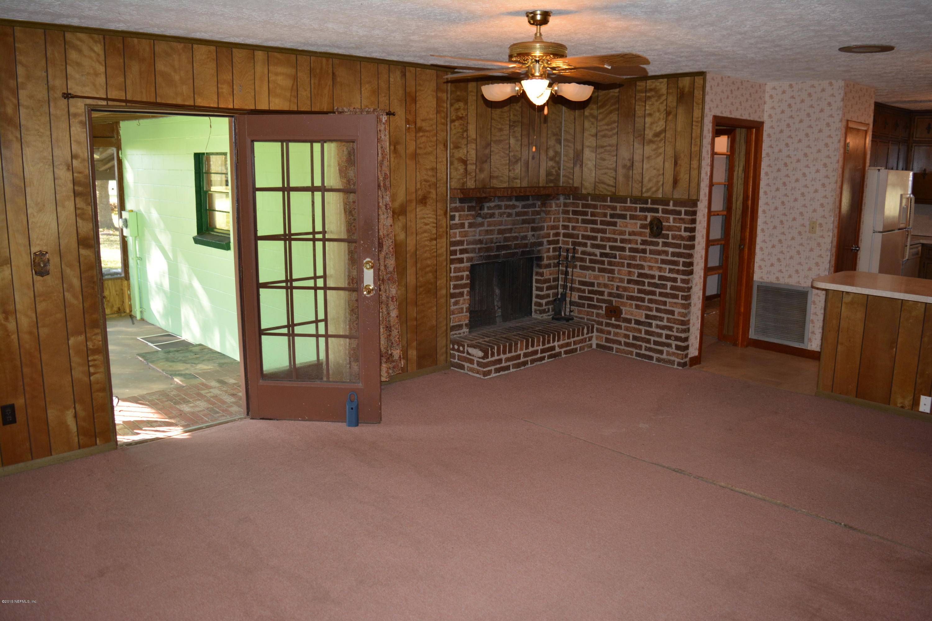 4061 Appaloosa Road Middleburg, FL 32068 - Photo 8 of 43 a view of an empty room with a fireplace and a window