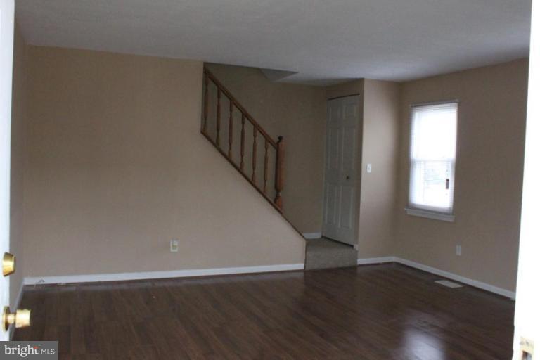 9415 Windpine Road, Unit 9415 Middle River, MD 21220 - Photo 6 of 11 a view of an empty room with wooden floor and a window