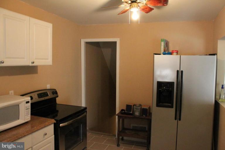 9415 Windpine Road, Unit 9415 Middle River, MD 21220 - Photo 9 of 11 a kitchen with a refrigerator and cabinets