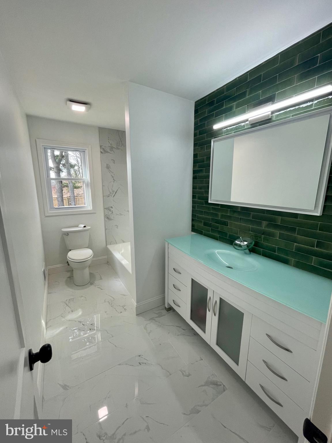 50 Tar Heels Road Hamilton, NJ 08619 - Photo 8 of 28 a bathroom with a toilet sink and mirror