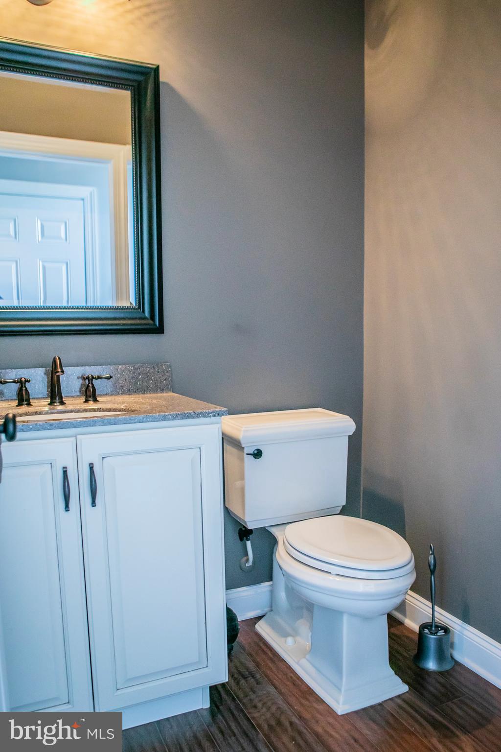 90 Lilac Road Malvern, PA 19355 - Photo 19 of 39 a bathroom with a toilet sink vanity and mirror