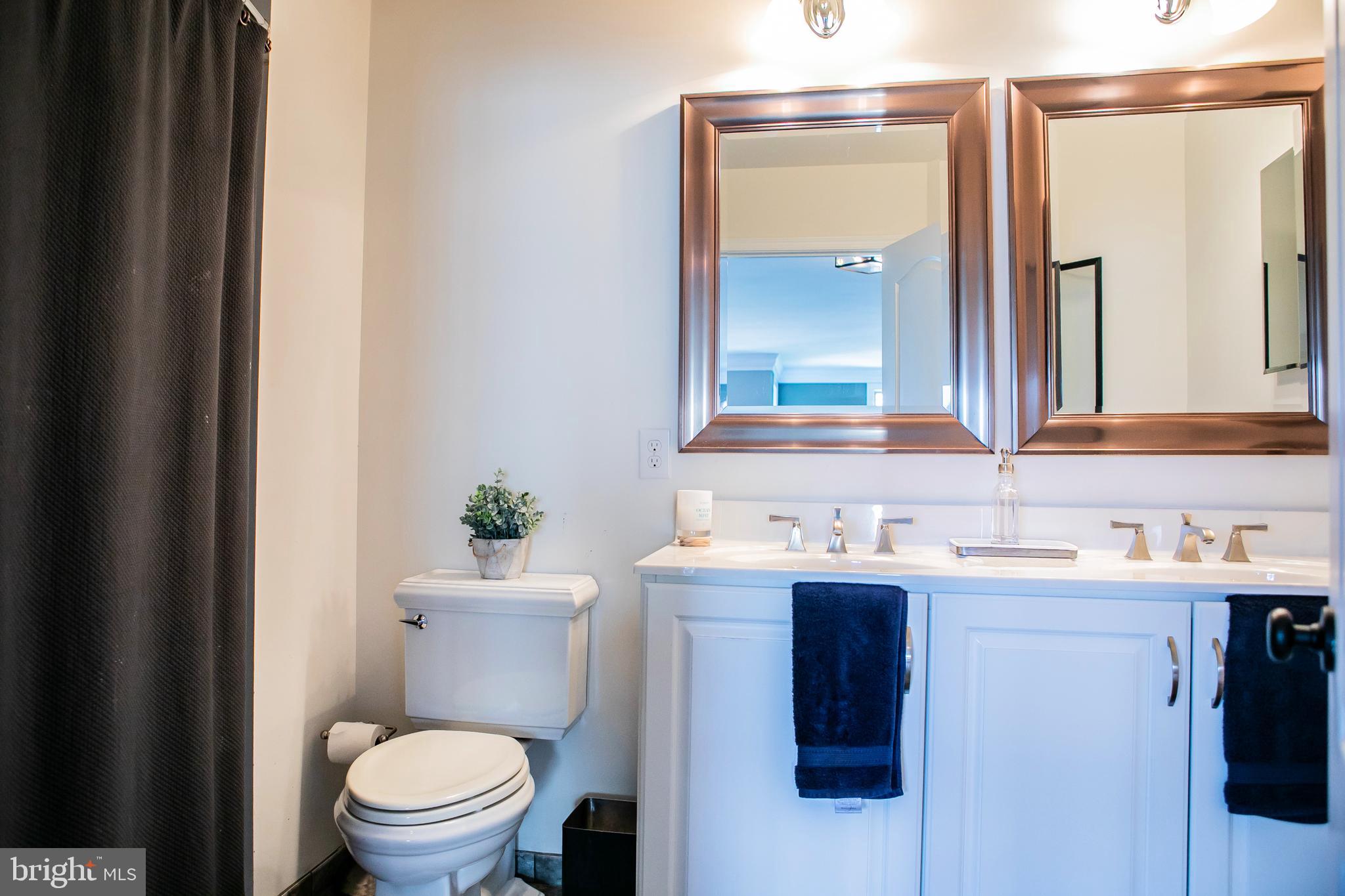 90 Lilac Road Malvern, PA 19355 - Photo 24 of 39 a bathroom with a toilet a sink and mirror