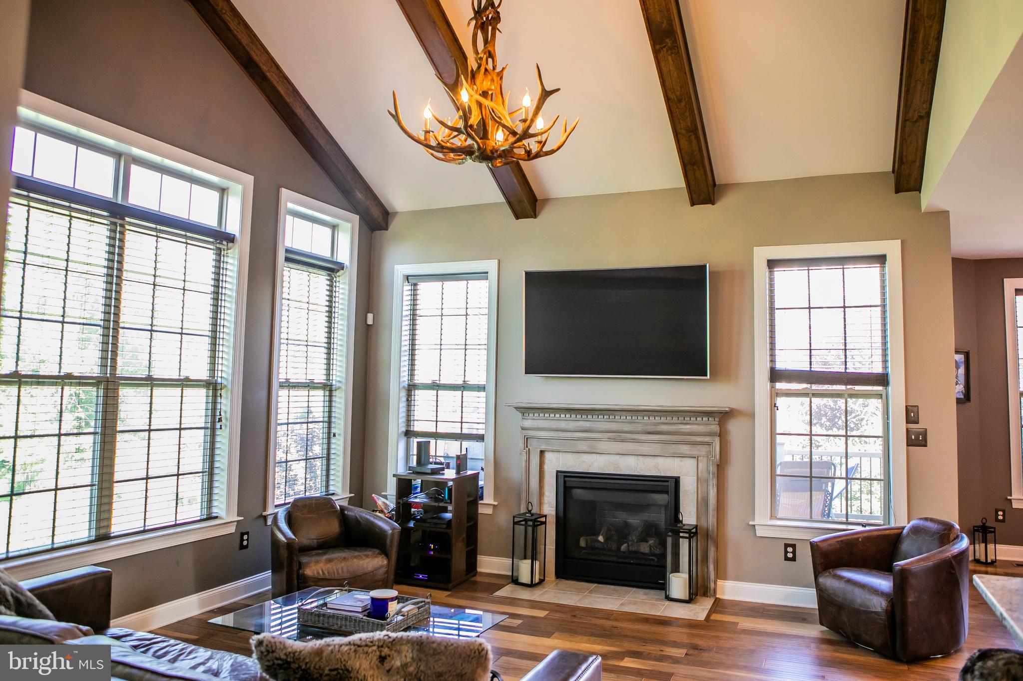90 Lilac Road Malvern, PA 19355 - Photo 7 of 39 a living room with furniture a fireplace and a flat screen tv