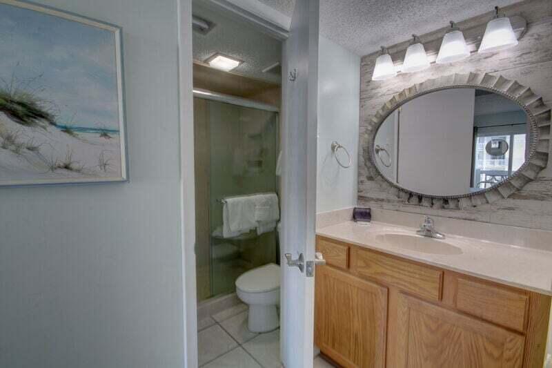 909 Santa Rosa Boulevard, Unit 358 Fort Walton Beach, FL 32548 - Photo 13 of 16 a bathroom with a toilet a sink and mirror