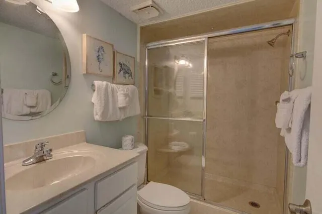a bathroom with a sink toilet and shower