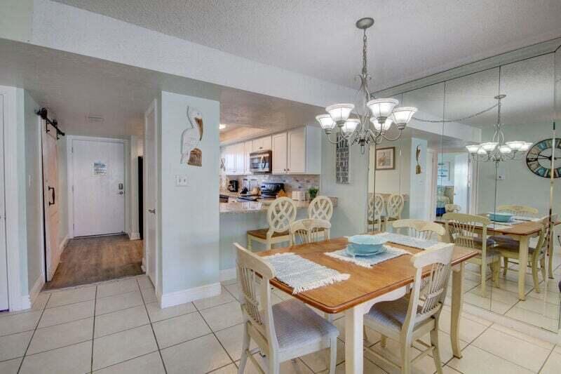 909 Santa Rosa Boulevard, Unit 358 Fort Walton Beach, FL 32548 - Photo 6 of 16 a view of a dining room with furniture and chandelier