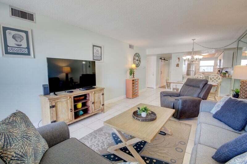 909 Santa Rosa Boulevard, Unit 358 Fort Walton Beach, FL 32548 - Photo 10 of 16 a living room with furniture and a flat screen tv