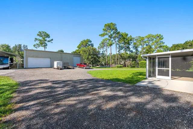a view of a house with a yard and garage