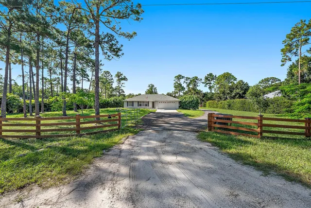 an aerial view of a house with a yard and fountain