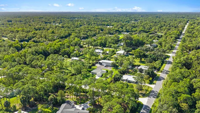 an aerial view of a house with outdoor space and lake view