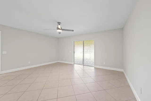 a bathroom with a granite countertop sink a toilet a mirror and shower