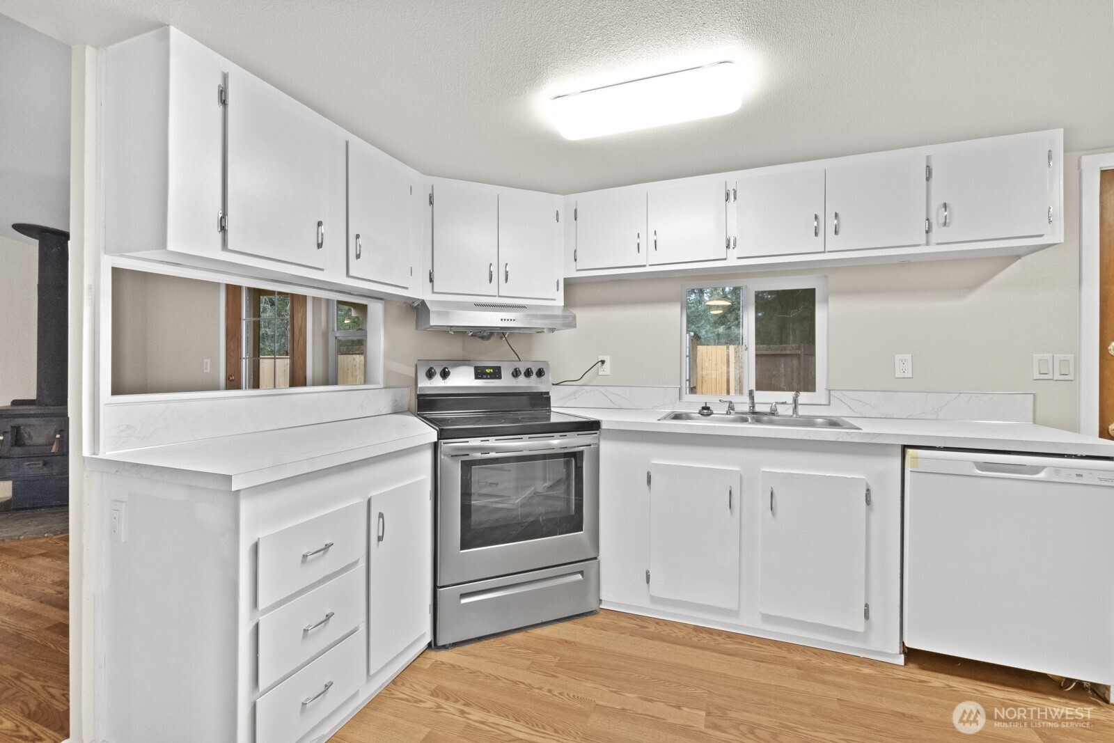 510 Duterrow Road Southeast, Unit 4 Olympia, WA 98513 - Photo 11 of 37 a kitchen with white cabinets and white appliances