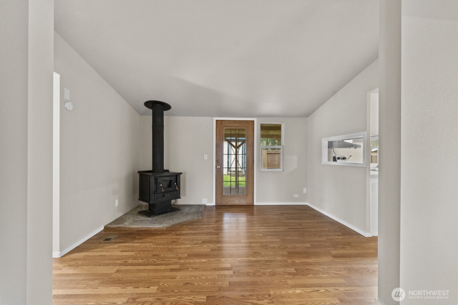 510 Duterrow Road Southeast, Unit 4 Olympia, WA 98513 - Photo 7 of 37 a view of an empty room with wooden floor and a window