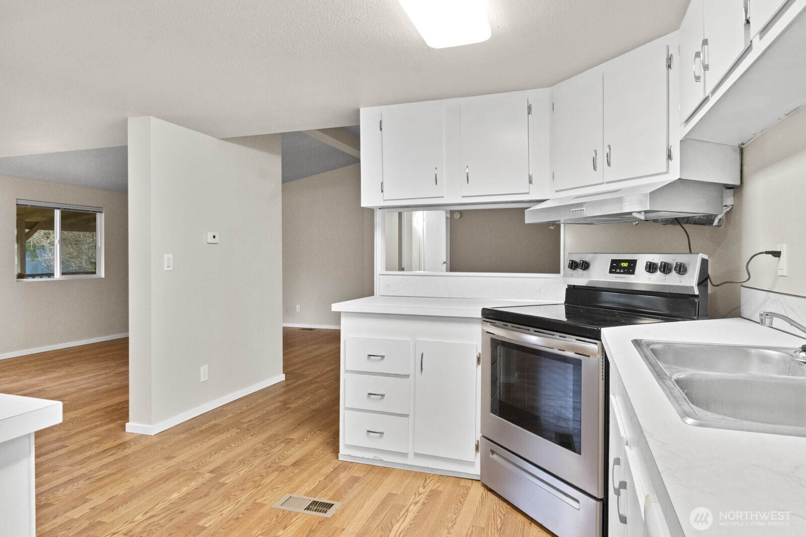 510 Duterrow Road Southeast, Unit 4 Olympia, WA 98513 - Photo 10 of 37 a kitchen with white cabinets and white appliances