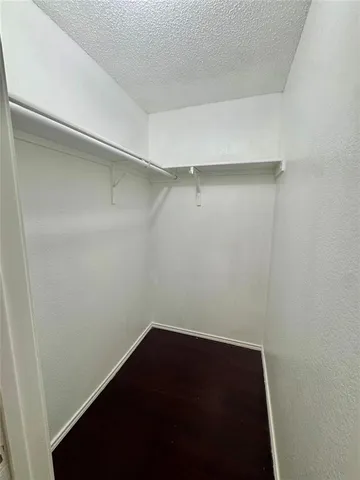 a bedroom with a bed and a refrigerator