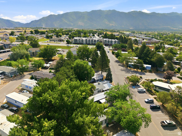 2875 North Hill Field Road, Unit 62 Layton, UT 84041 - Photo 28 of 34 Aerial overview of a residential area with mature trees and paved roadways