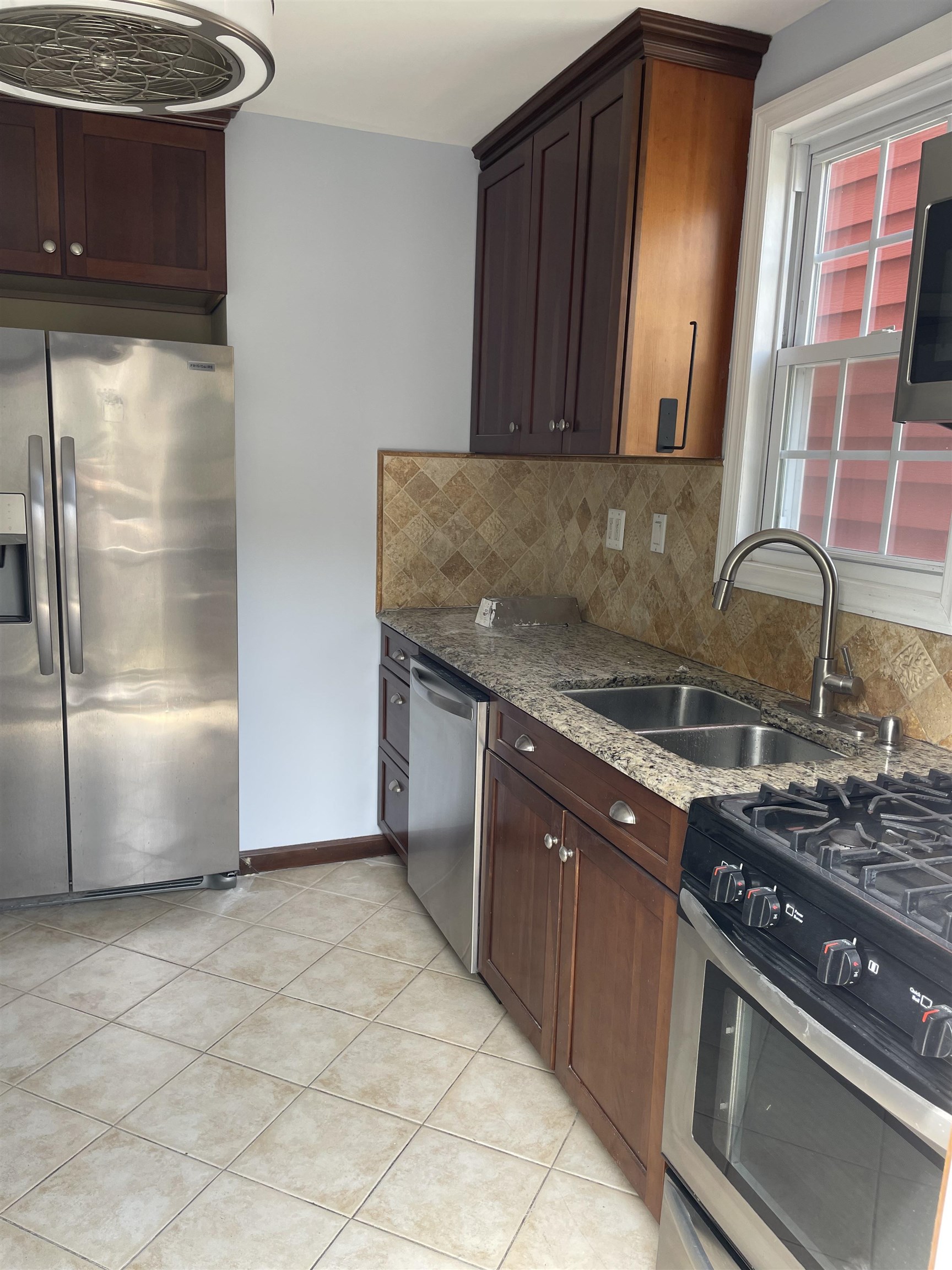 148 Nesbit Street, Unit 1 Weehawken, NJ 07086 - Photo 2 of 13 a kitchen with granite countertop a stove and a refrigerator