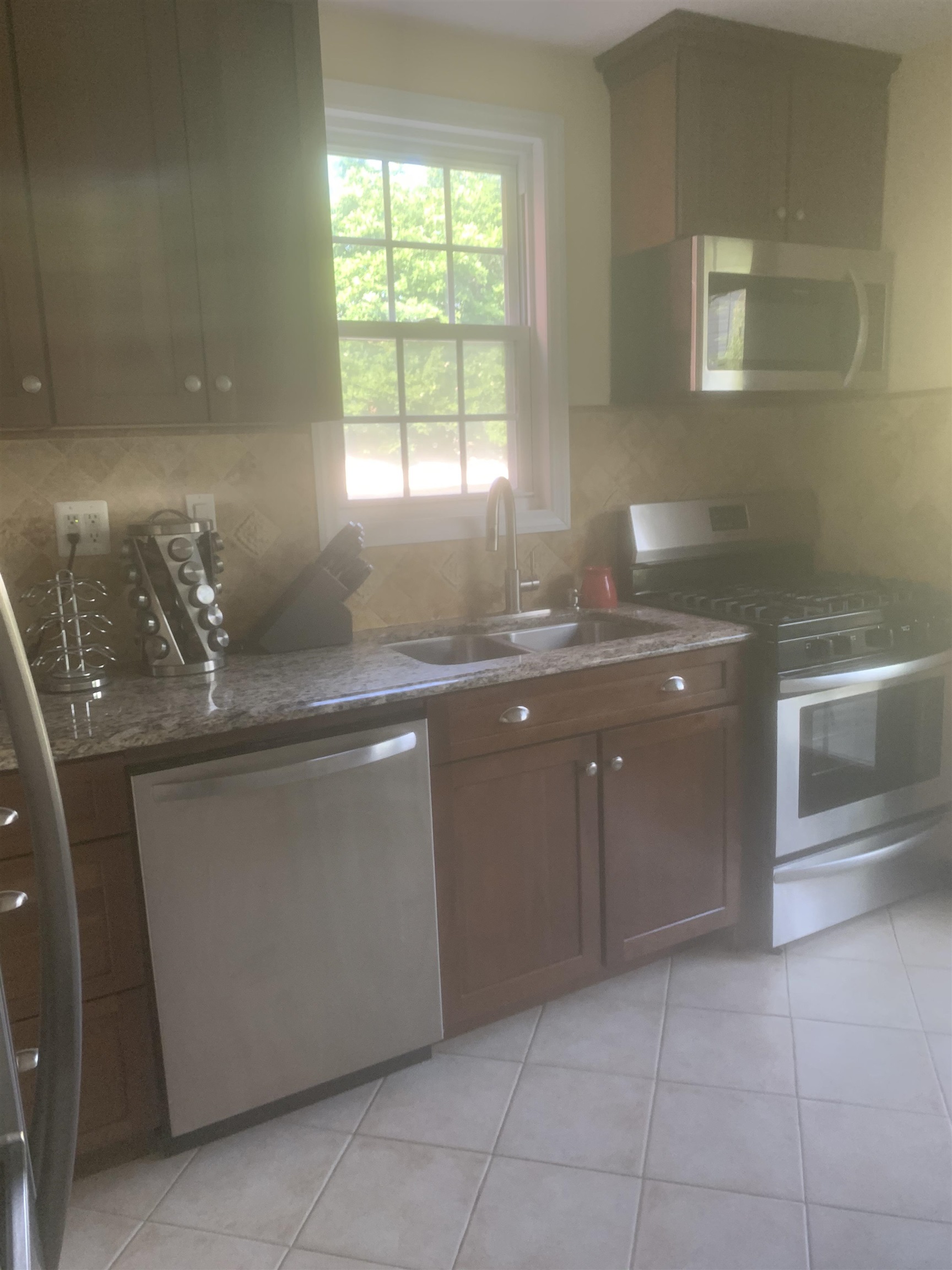 148 Nesbit Street, Unit 1 Weehawken, NJ 07086 - Photo 3 of 13 a kitchen with granite countertop a sink and a stove