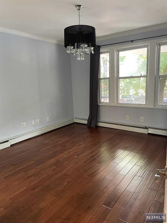 148 Nesbit Street, Unit 1 Weehawken, NJ 07086 - Photo 5 of 13 an empty room with wooden floor and windows