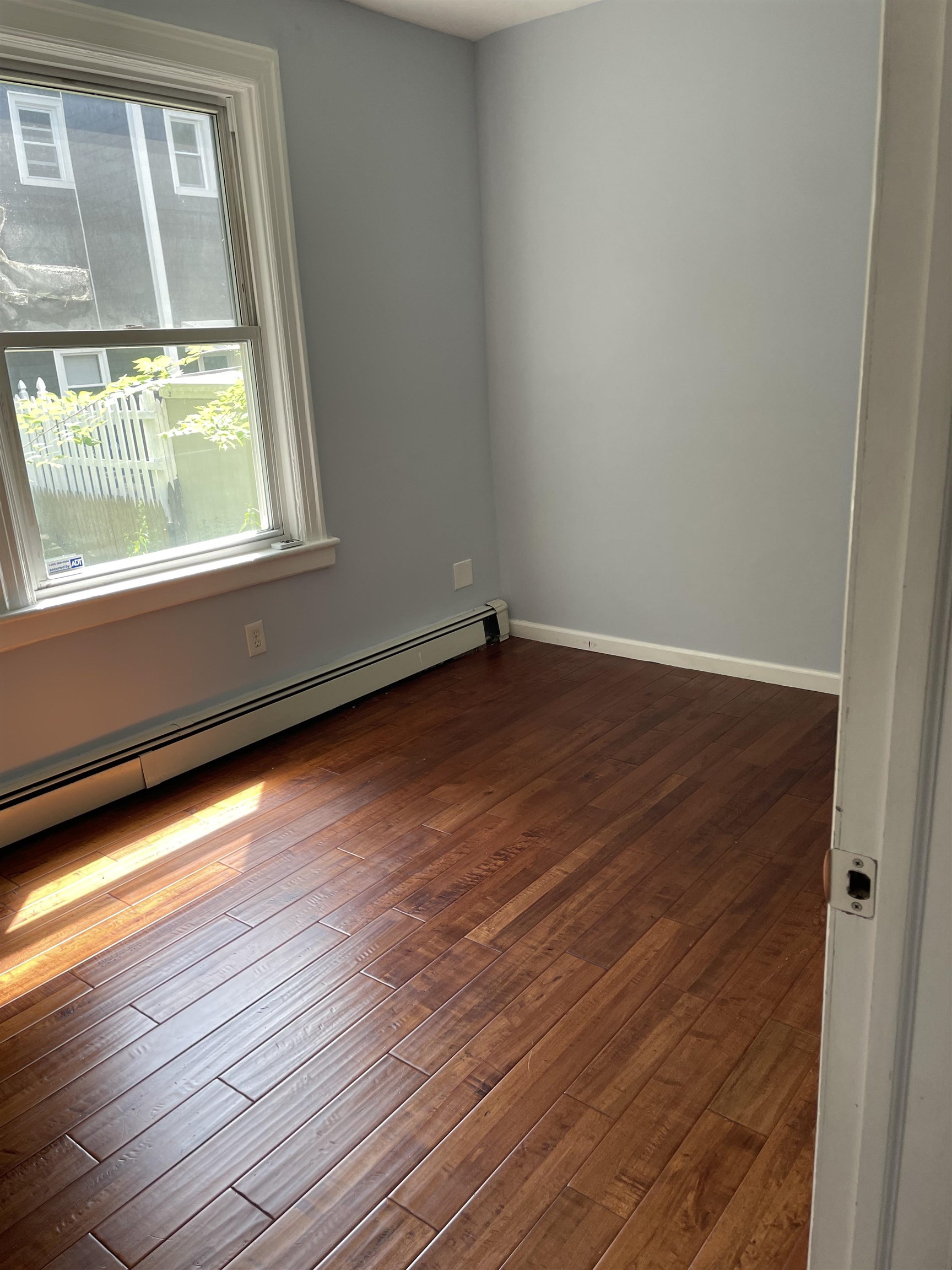 148 Nesbit Street, Unit 1 Weehawken, NJ 07086 - Photo 6 of 13 a view of an empty room with wooden floor and a window