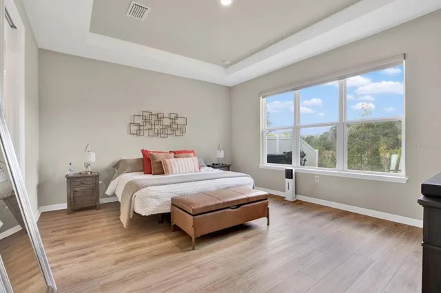 a bedroom with a bed and a large window