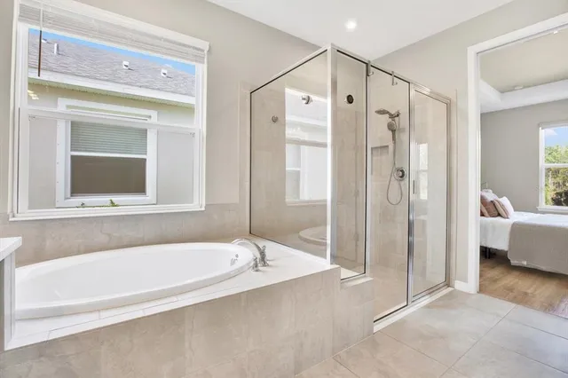 a spacious bathroom with a large tub shower and sink