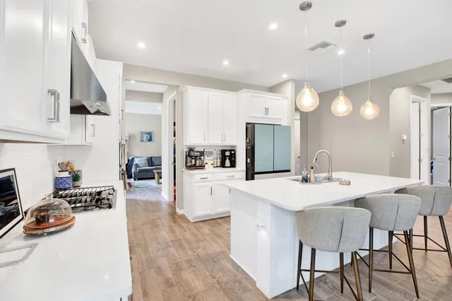 a kitchen with stainless steel appliances kitchen island granite countertop a sink and cabinets