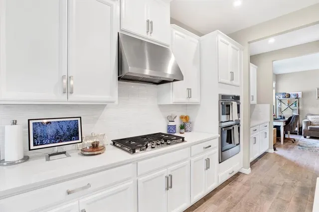 a kitchen with stainless steel appliances a stove a microwave and cabinets